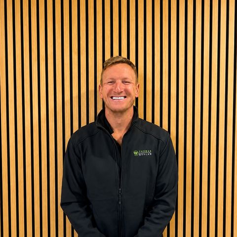 A Thomas Electrical and Solar team member in a branded jacket